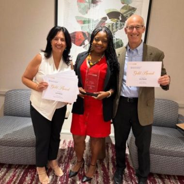 L.A. Parent publishers and editor celebrate national wins at the 2025 Parenting Media Association Awards in Chicago, holding Gold Award certificates and trophy.