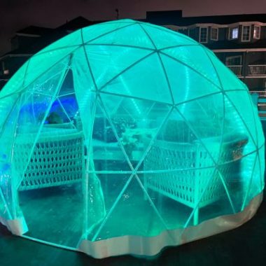 Green-lit dining igloo at Laguna Cliffs Resort & Spa.