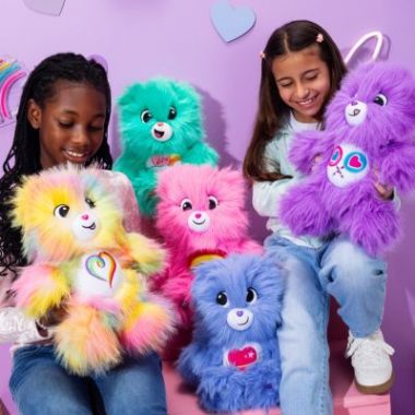 Girls hold Care Bears Super Fuzzies plush collection, featuring extra-soft Bashful Heart Bear and Cheer Bear.
