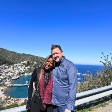 The author and her husband pose before a background of Catalina Island.