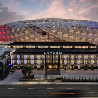 The Anthem hotel in Inglewood sits beside Intuit Dome in the Los Angeles Stadium District at dusk.