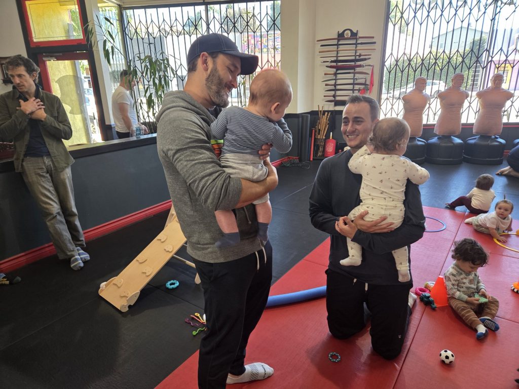 Dads connecting while their children play together.