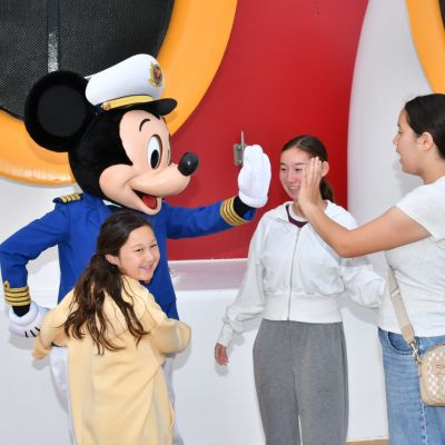 Mickey Mouse with guests on Disney cruise ship at the Port of San Diego, where sailings are expanding through 2031.