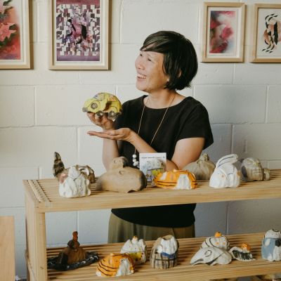 Alyson Iwamoto holds up a ceramic in her ceramics studio.