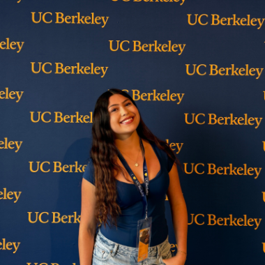 Haley Castanaza stands in front of a UC Berkeley step-and-repeat sign.