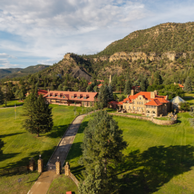 Aerial view of Vermejo, a Ted Turner Reserve, surrounded by forested mountains in northern New Mexico.